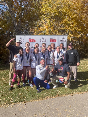 Herriman High School girl's wrestling team posing with their medals.